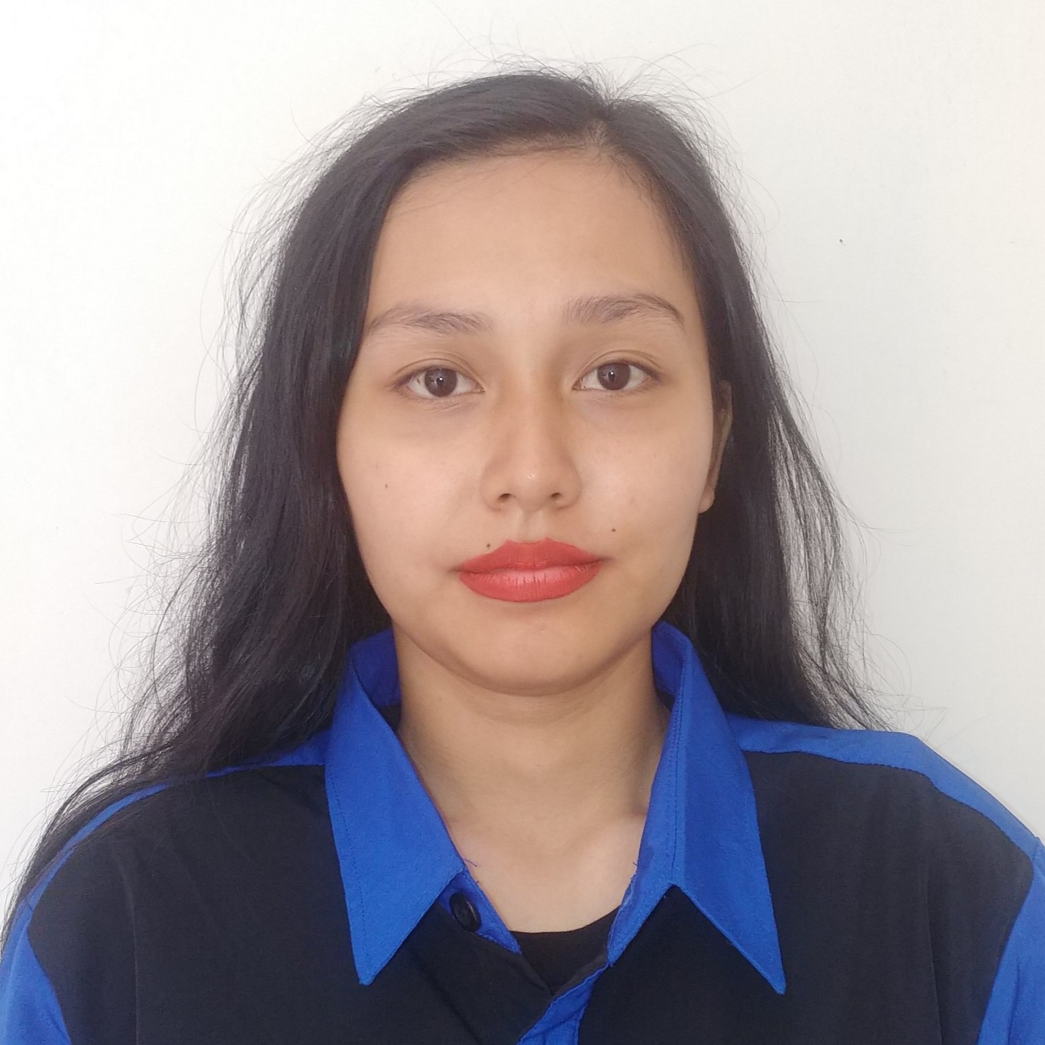 A woman with red lipstick and black-marine blue field uniform